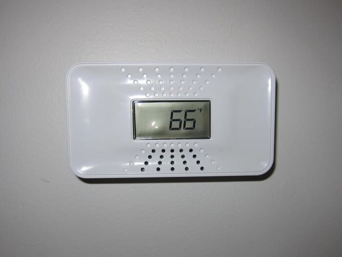 Digital thermostat displaying 66°F, one of Amazon's movers and shakers, mounted on a beige wall.