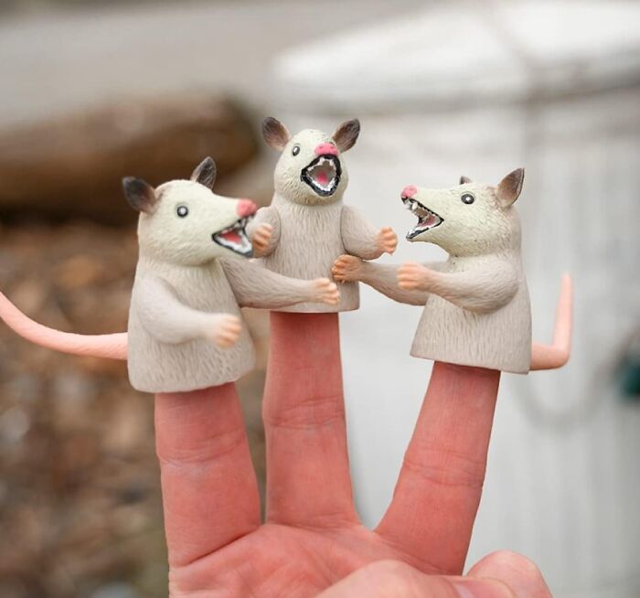 Finger puppets of three cartoon mice with open mouths, a ridiculous find.