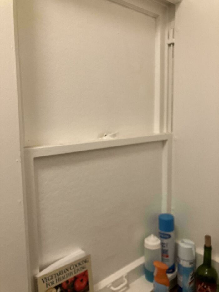 Empty open wall shelf with assorted items, highlighting issues with landlords.