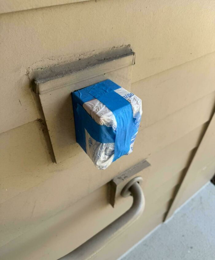 Electrical outlet covered with foil and blue tape, illustrating issues with landlords.
