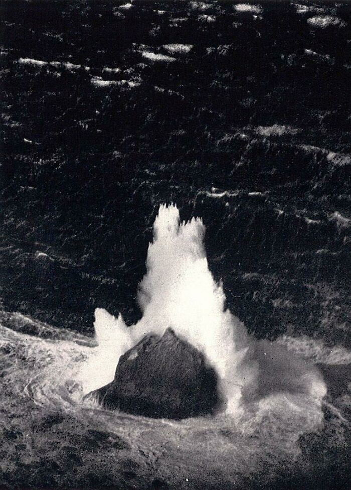 Massive wave crashing against a rocky ocean surface, capturing the scary power of the sea.