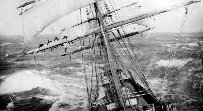 Sailing ship battling rough ocean waves, evoking fear of the sea.