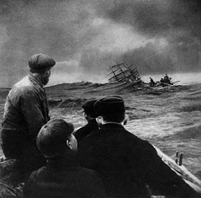 Sailors in small boats navigating stormy ocean waves near a sinking ship, highlighting fear of the ocean.