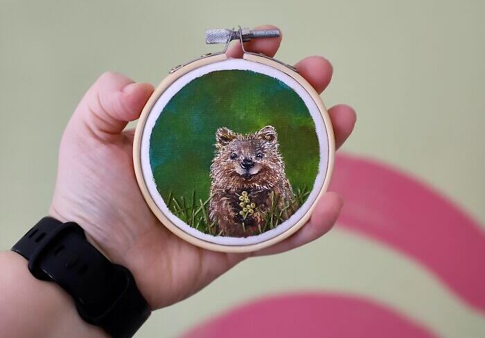 Hand holding embroidery hoop featuring a detailed quokka design, exemplifying incredible embroidery works.