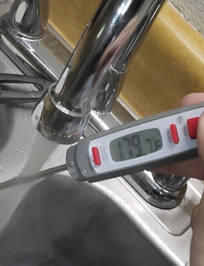 Thermometer showing 179.7°F in tap water, highlighting issues with landlords and hot water safety.