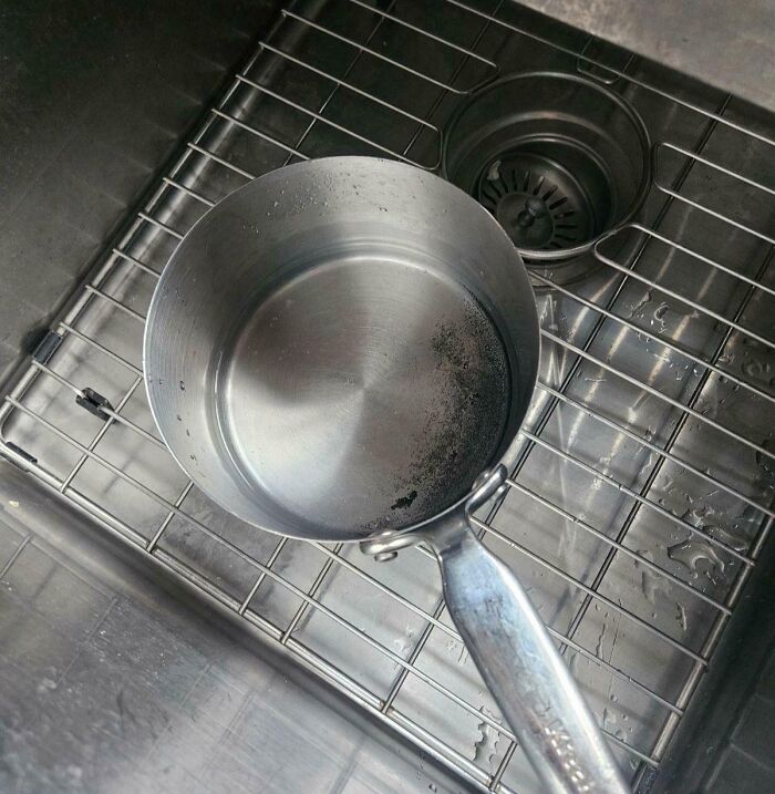 Olla metálica en un fregadero, fotografiada sin advertir peligro potencial.