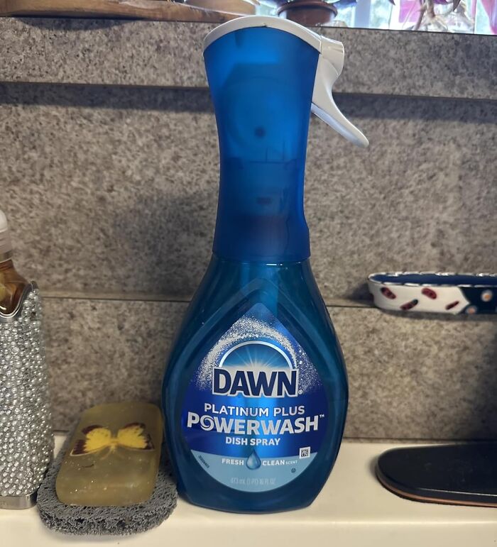 Dawn Powerwash Dish Spray bottle on a kitchen counter, featured in a 40K review club selection on Amazon products.
