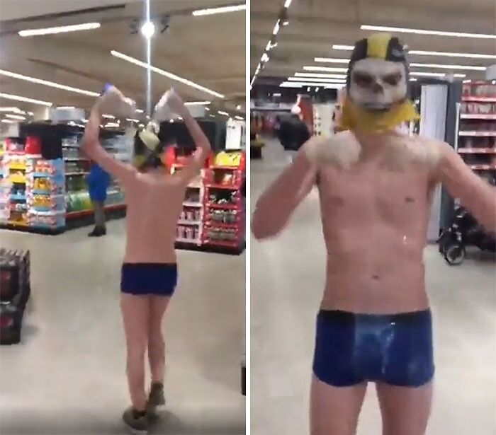 Man in a supermarket wearing a mask and shorts, raising arms. Self-awareness lacks in public behavior.