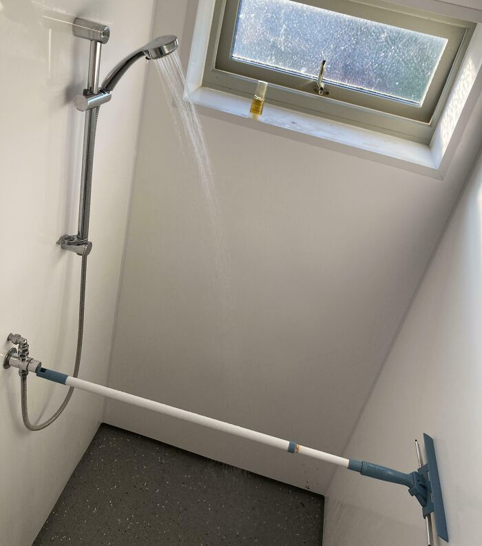 Shower repair fail with a window cleaning tool used to hold a shower head horizontally.