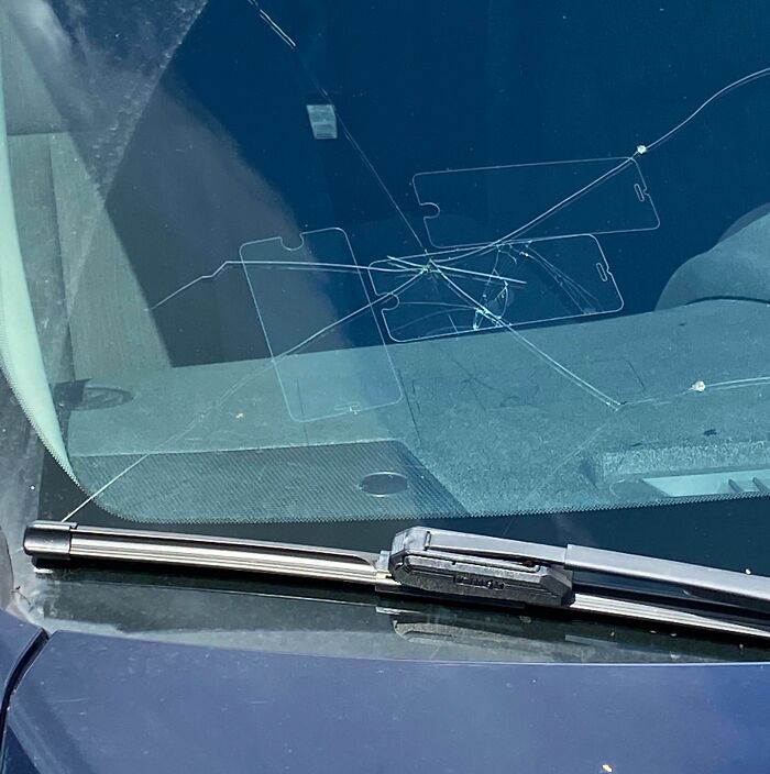 Failed repair attempt on a c*****d windshield using transparent phone cases.