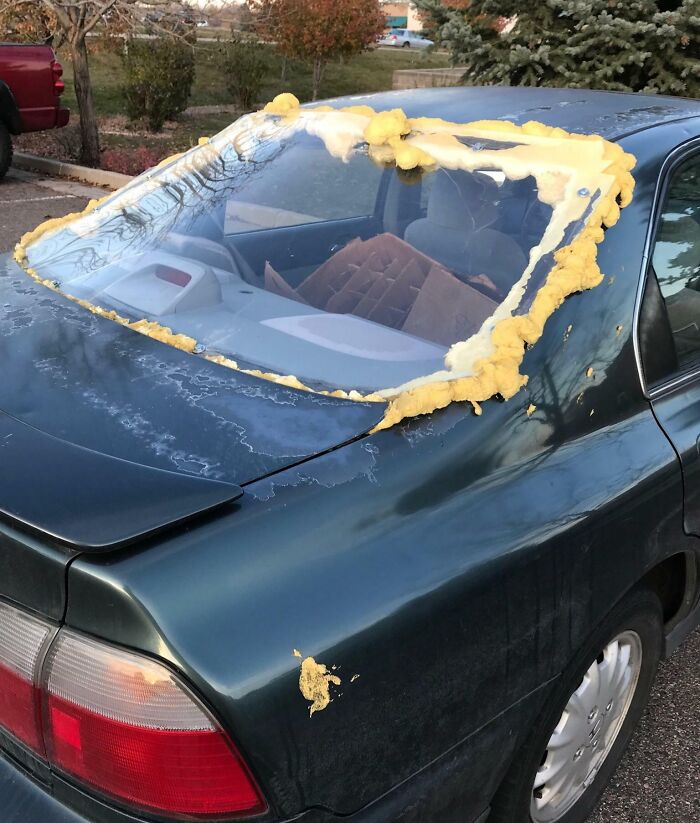 Car window repair attempt with foam sealant, showcasing a failed repair effort.
