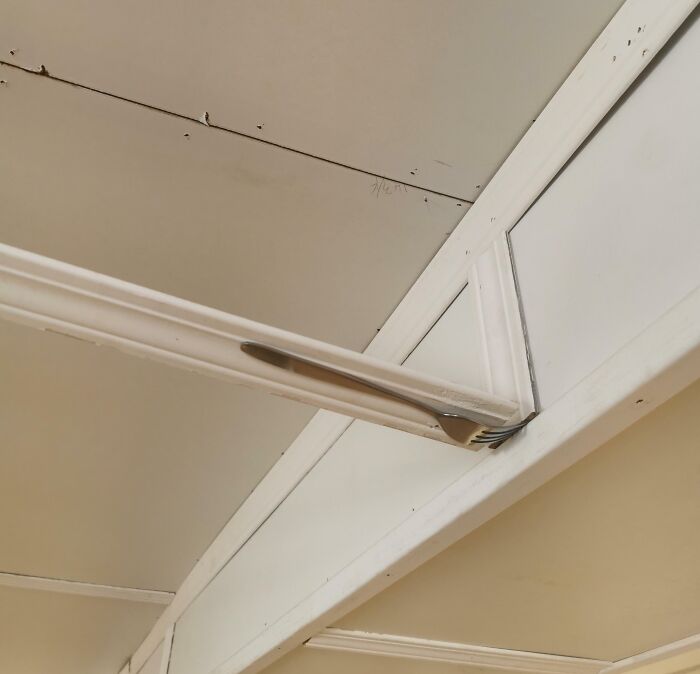 Failed repair attempt with a fork wedged between ceiling beams.