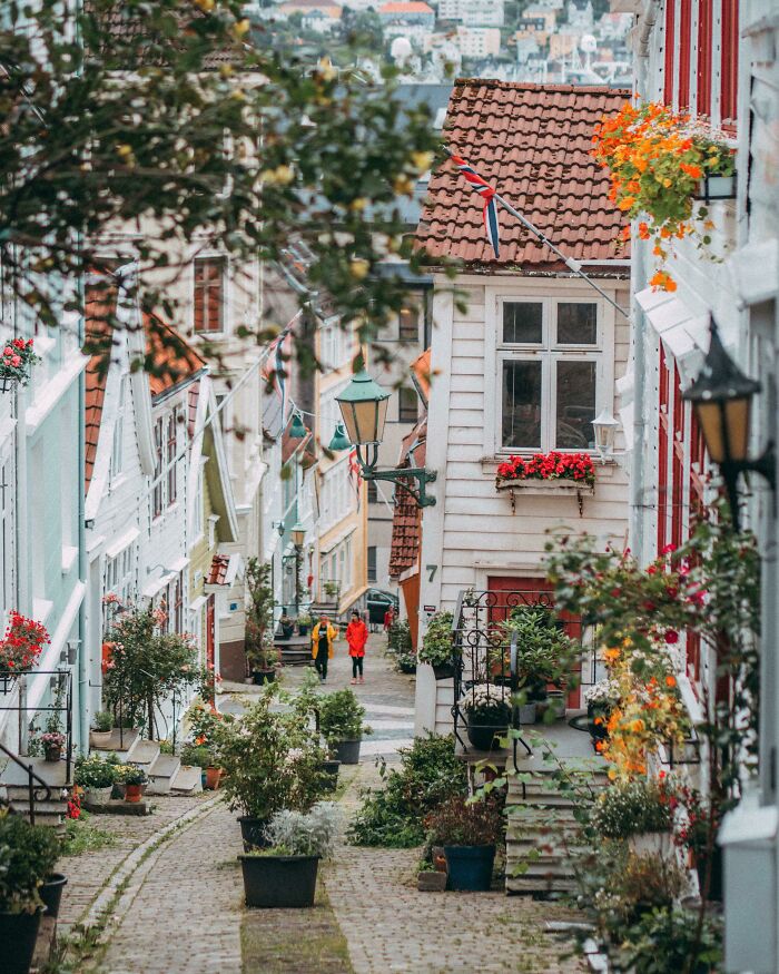 Charming street with colorful houses and flowers, showcasing one of the most beautiful places discovered.