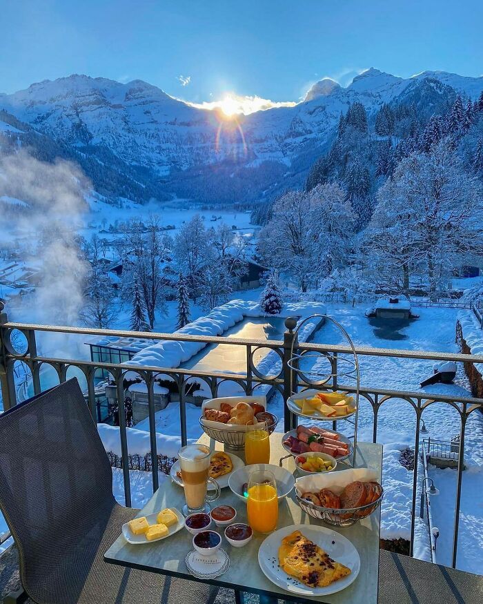 Beautiful winter mountain view with breakfast on a snowy balcony.