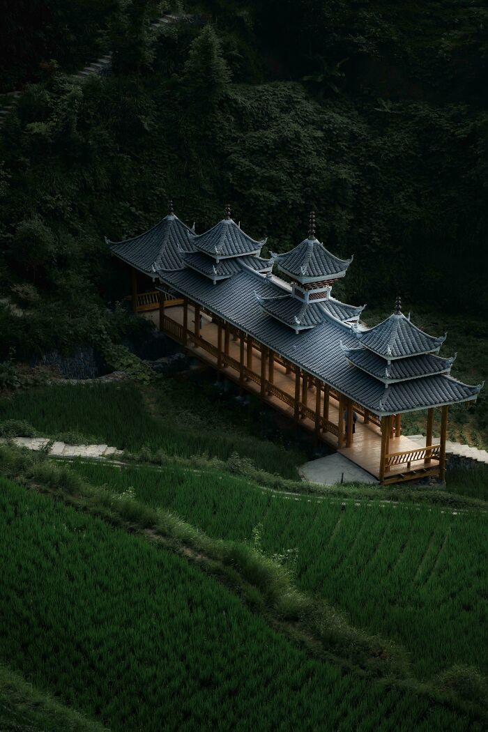 A serene pavilion nestled among lush greenery showcases a beautiful place in nature.