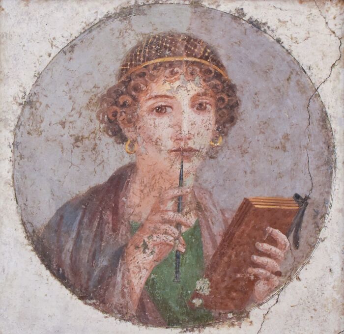 Ancient Roman woman holding a stylus and wax tablet, showcasing Roman Empire art and writing culture.