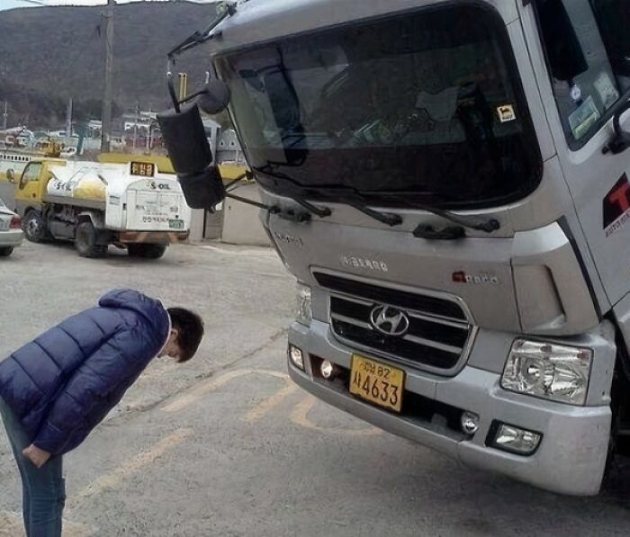 Person bowing to a leaning truck in a humorous scene from random Instagram images.