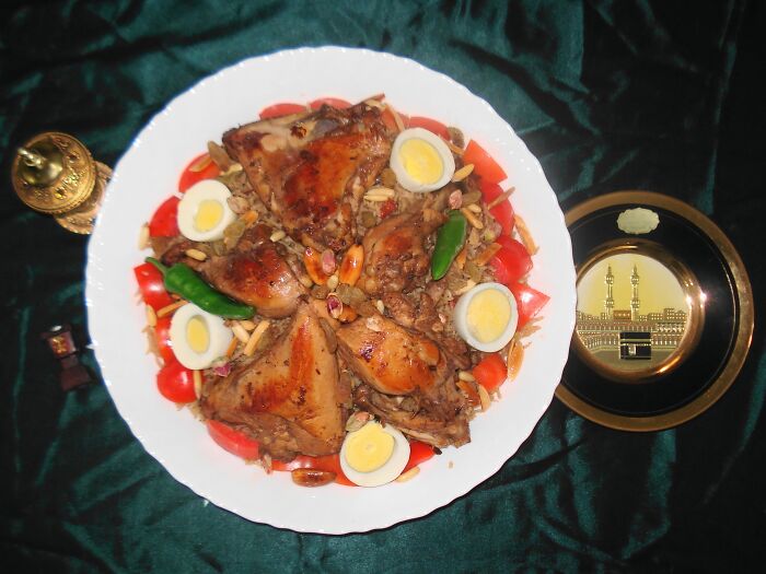 Aromatic top dish with baked chicken, boiled eggs, and vegetables served on a decorative dish.