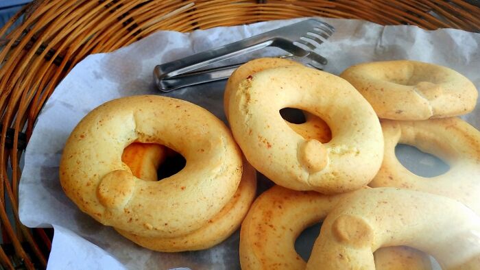 Traditional top dish, crispy ring-shaped bread on parchment in a basket from different countries.