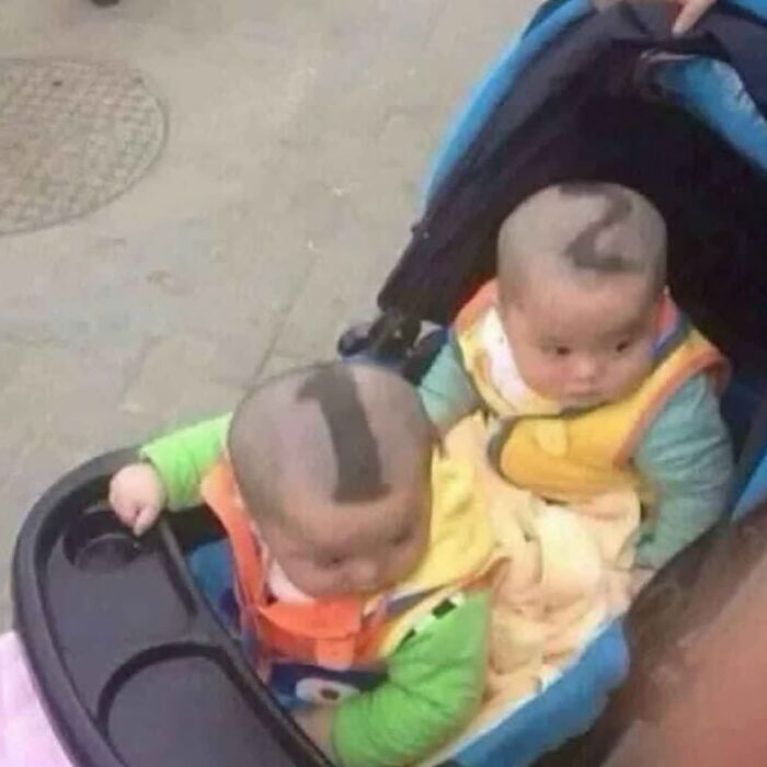 Two babies in a stroller with funny haircuts resembling numbers, shared by random image Instagram accounts.