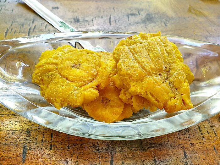 Golden fried plantains on a glass dish, a top dish from different countries.