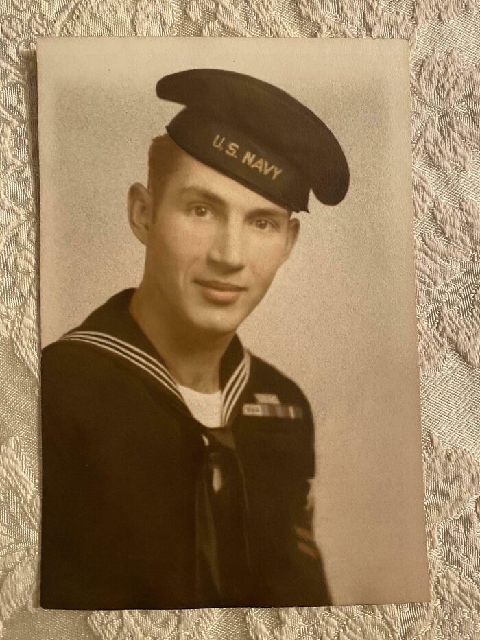 Black and white vintage photo of a young US Navy sailor in uniform, a fascinating old image from history class.