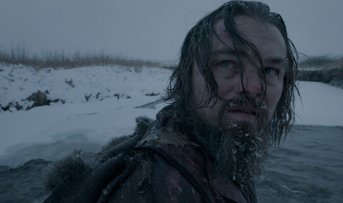 Actor with frost on beard and wet hair in snowy frozen landscape, showcasing dedication for difficult roles.