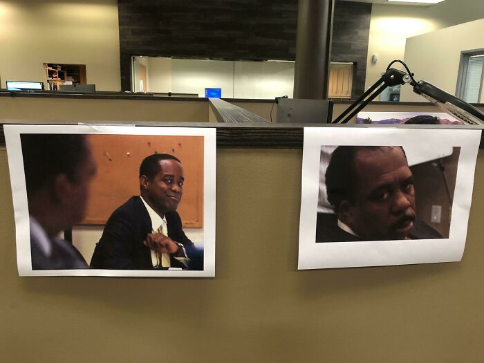 Funny coworkers' meme photos on an office cubicle wall display humor at work.