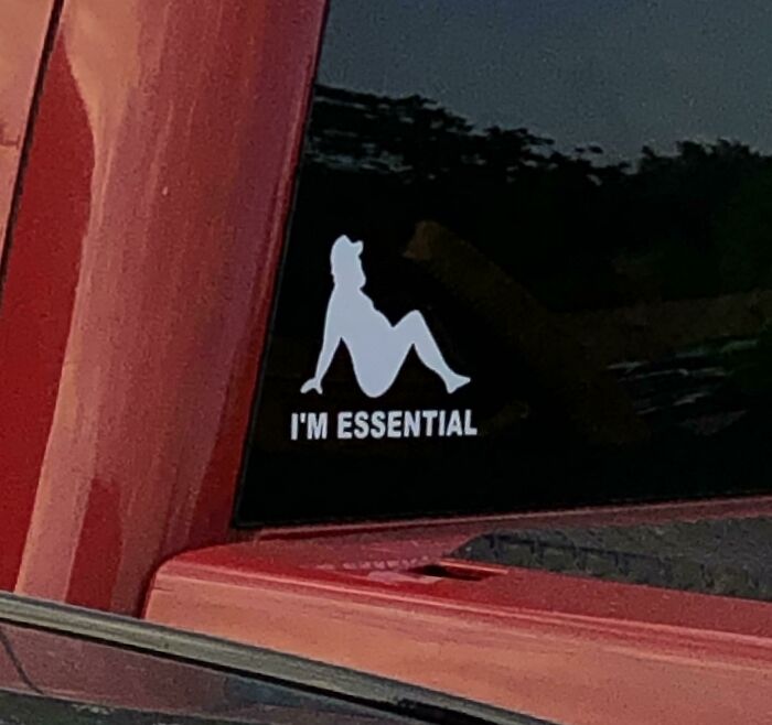 Decal on red truck with humorous silhouette and "I'm Essential" text, highlighting funny coworkers.