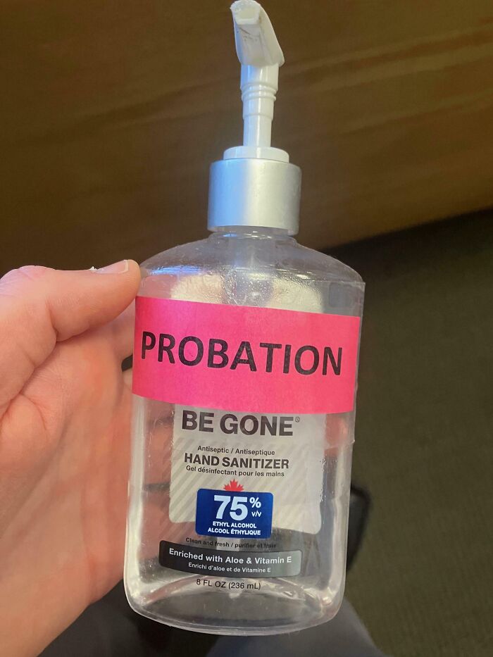 Funny coworker labeled hand sanitizer bottle with "PROBATION," showcasing office humor.