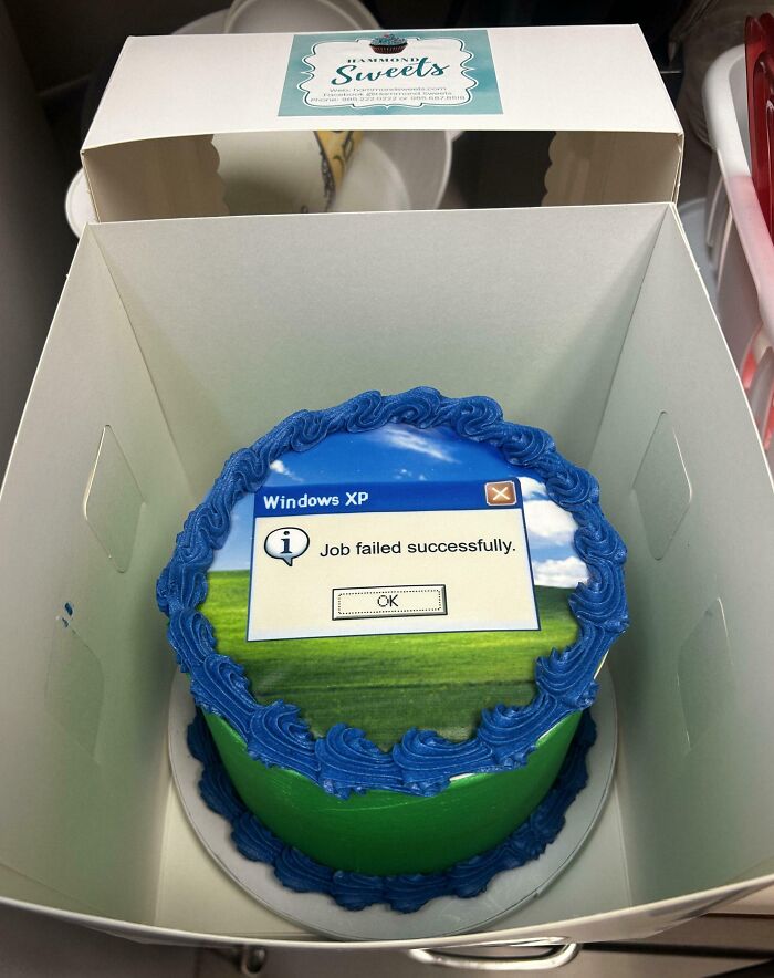 Cake with Windows XP error message, "Job failed successfully," showcasing humorous coworker creativity.