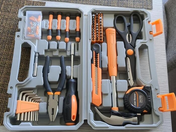 Tool kit essentials for solo living, featuring screwdrivers, pliers, and a hammer.