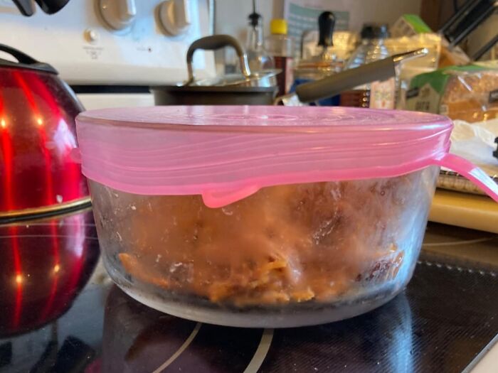 Sealed food container on a stove, ideal for solo living convenience and backup.