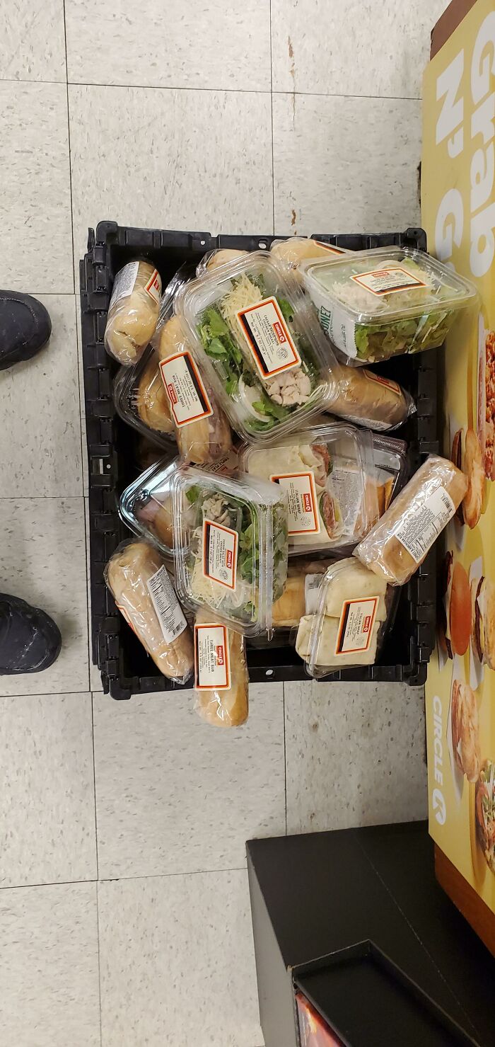 Grocery store sandwiches in a plastic crate, showcasing an example of online frustration over excessive packaging.