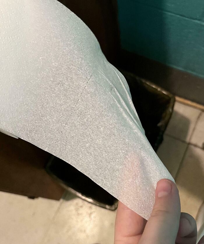 Transparent toilet paper held by a hand, depicting a humorous situation related to infuriating bosses.