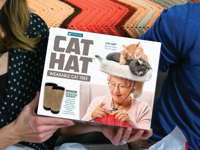 Box of a "Cat Hat" wearable cat tree for the weird friend, featuring person knitting with cats on their head.