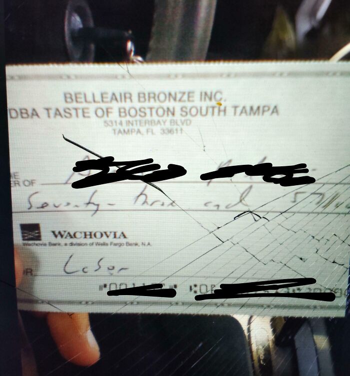 Check with scribbles over writing, representing a frustrating boss moment.