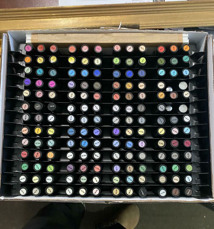Box of colorful markers neatly organized, showcasing a variety of vibrant hues.