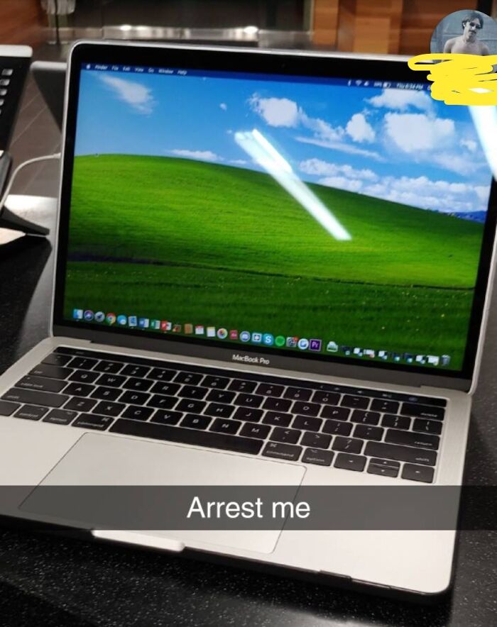 A laptop with a humorous message, showing the classic Windows XP wallpaper.