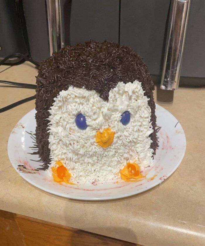 A penguin-themed cake showcasing creative culinary concoctions on a kitchen counter.