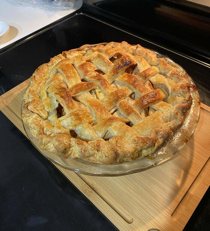 Golden lattice pie on a wooden board, showcasing a high-level baking creation.