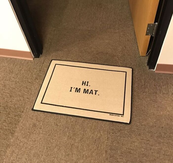 A doormat with humor, placed at an office entrance, reads "Hi. I'm Mat."
