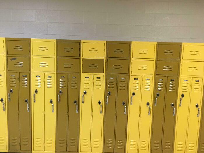 Yellow and gold school lockers in a hallway, illustrating aspects of American schools.