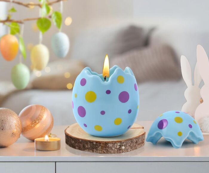 Polka dot egg candle on a wooden slice, surrounded by Easter decorations, perfect for an Easter basket treat.