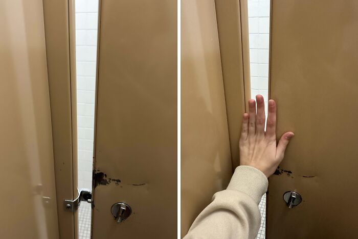 School bathroom door with privacy gap, hand showing space issue.