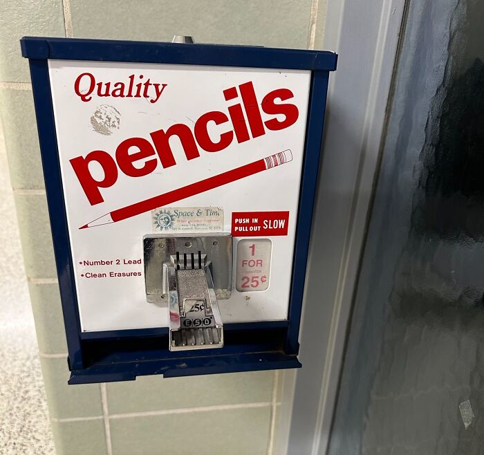 Pencil vending machine in American school hall offering quality pencils for 25 cents.