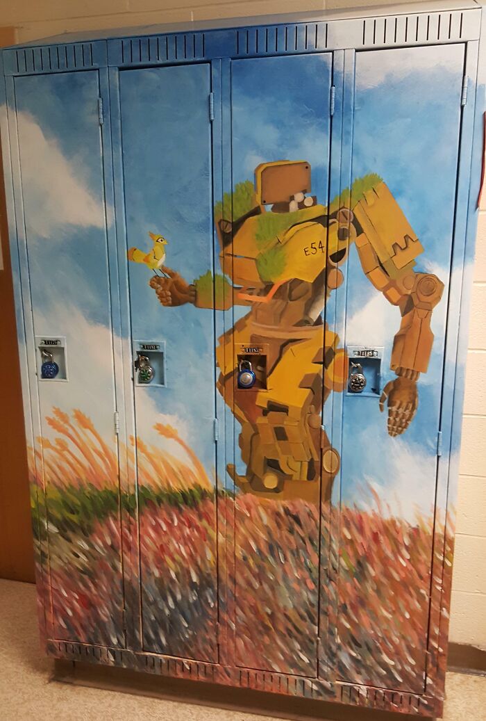 Colorful lockers with a painted robot in an American school hallway.