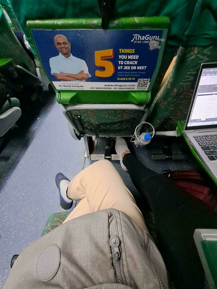 Overcrowded bus seat with passengers and laptop, highlighting lack of basic etiquette.