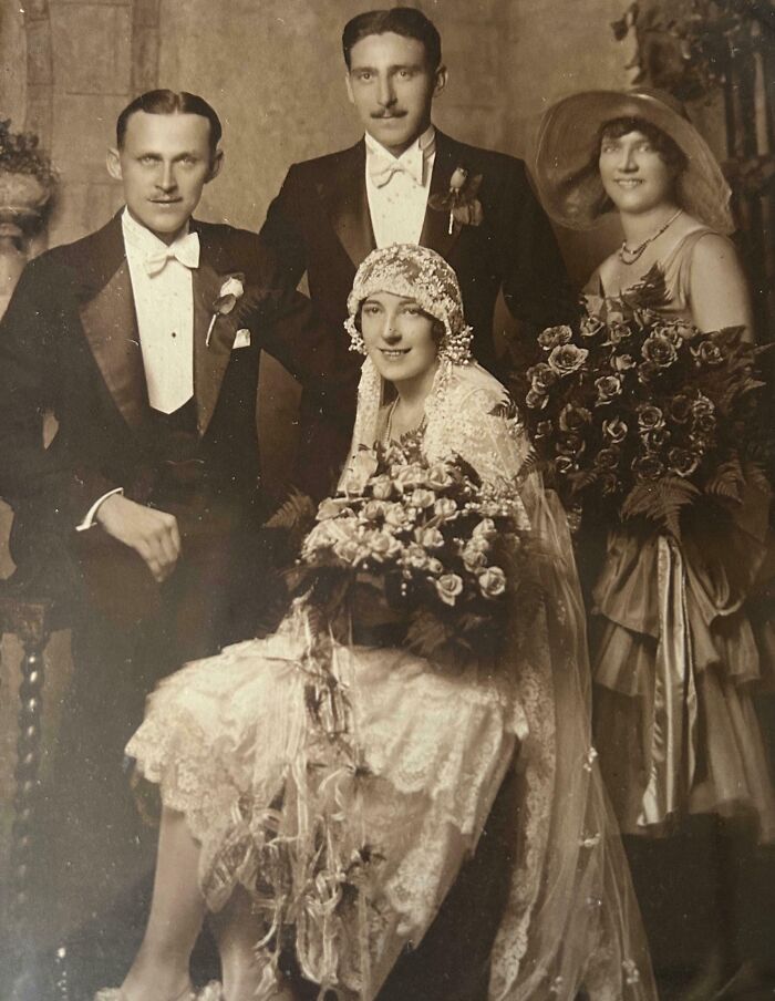 Vintage wedding photo with a bride in lace and groom in a tuxedo, showcasing timeless love and classic style.