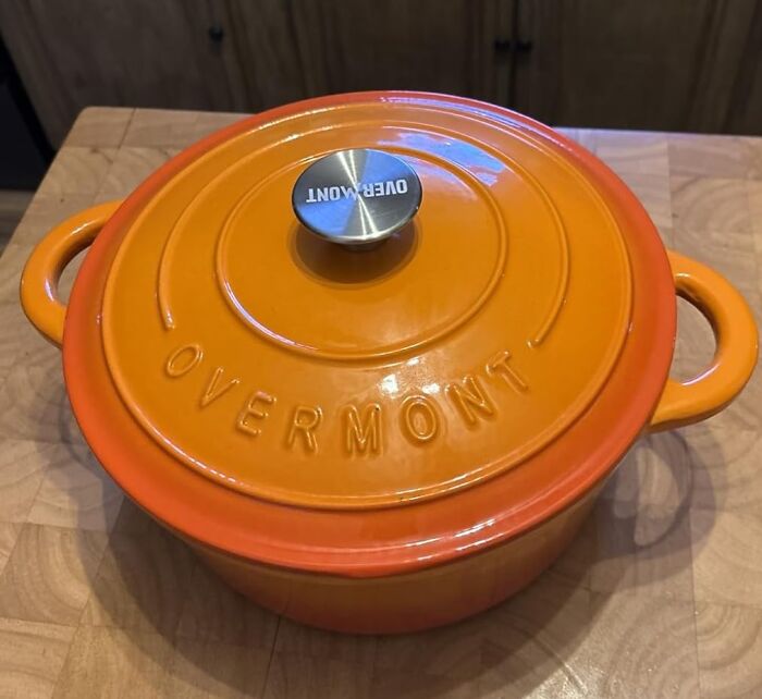 Orange Overmont Dutch oven on a wooden countertop, one of Amazon's most-wished-for items.